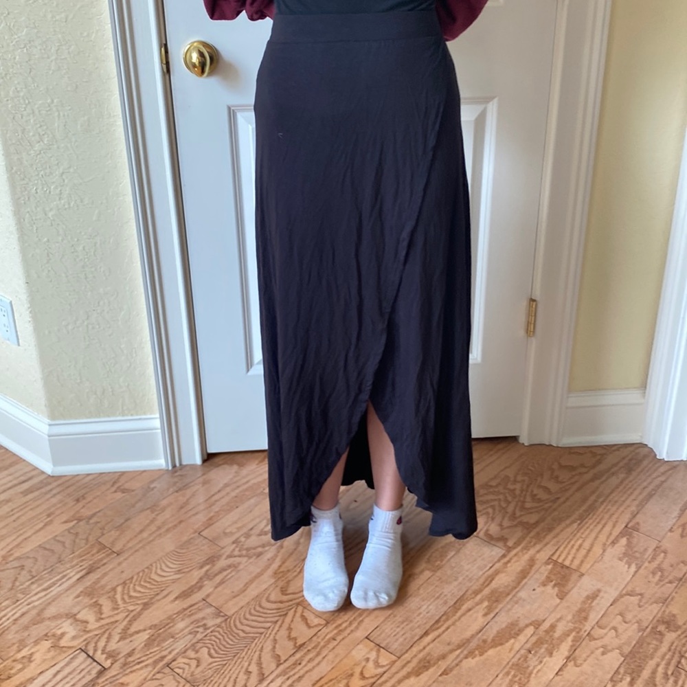 Long black skirt with slit at front.  Elastic waist band.  Medium